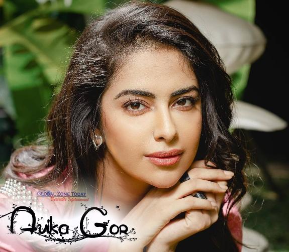 Actress Avika Gor is sitting outside wearing a pink dress