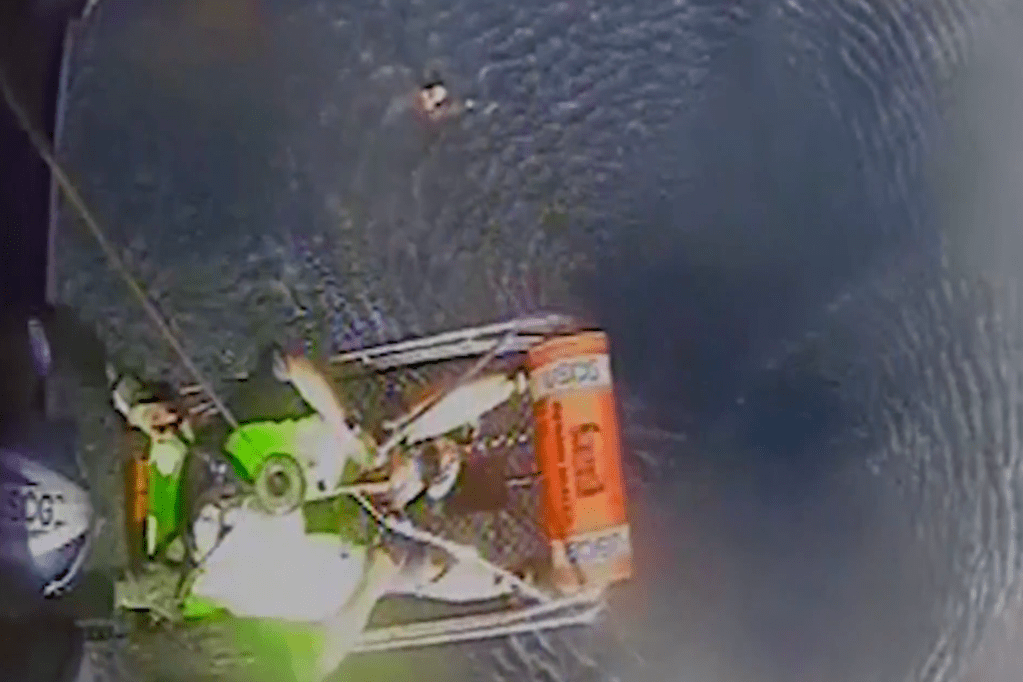 A Coast Guard chopper hovered above the boat in the Gulf of Mexico as the aircrew pulled the couple and their dog to safety. 