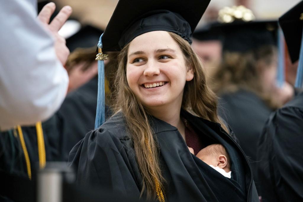 Michigan woman walks stage at college graduation with 10-day-old daughter inside gown