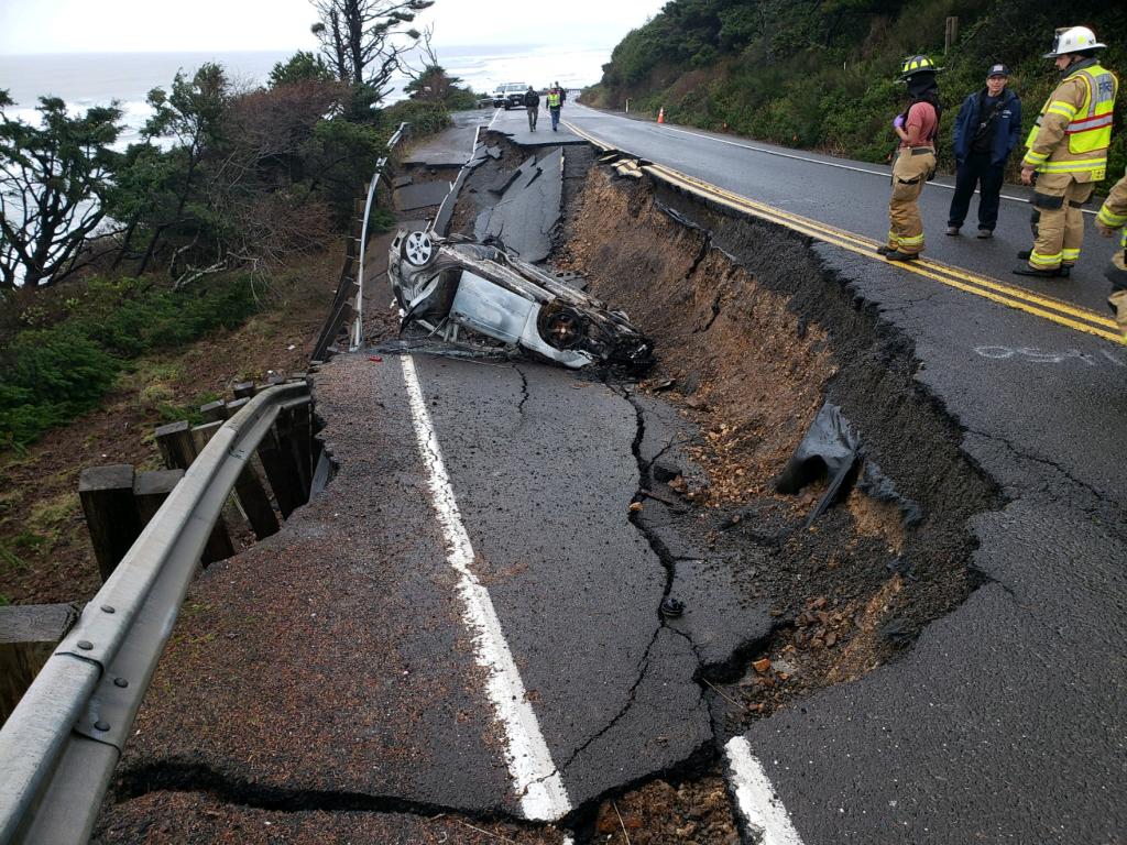 Car thief ignores road closure sign and careens into hole made by landslide